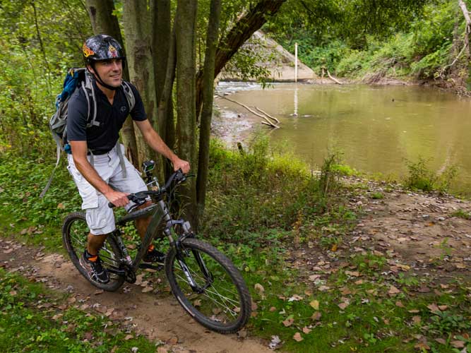 A man mountain biking on the Outback Trail at Imagination Glen in Indiana Dunes, Indiana