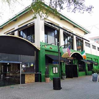 The outside of Fionn McCool’s Irish Pub in Jacksonville, Florida is painted green and decorated with an American and Irish flags