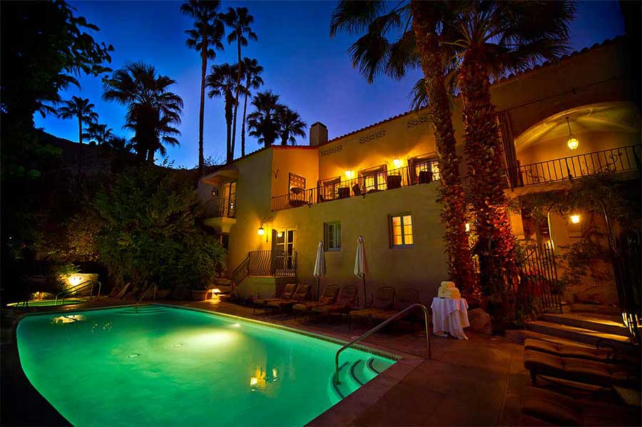 An evening view of the pool at The Willows Historic Palm Springs Inn