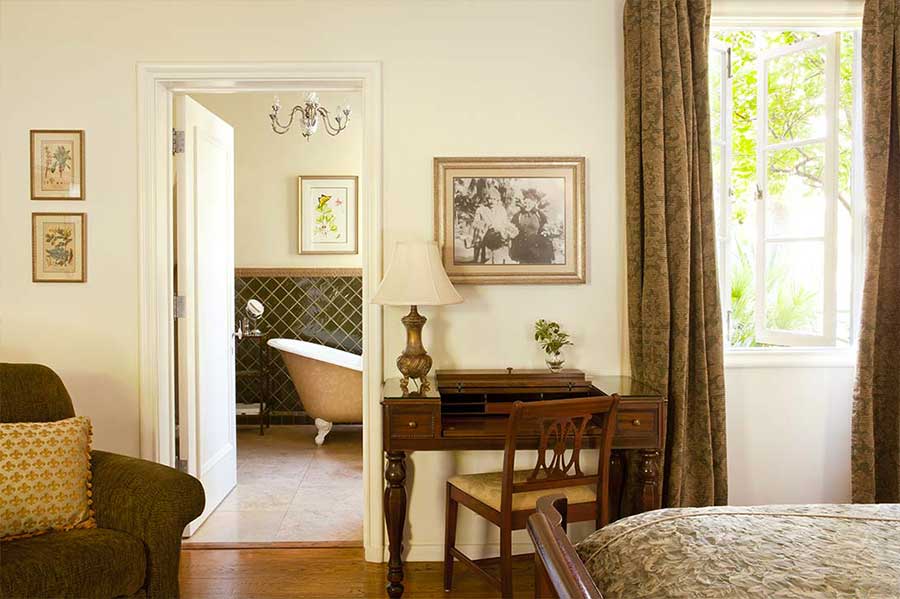 A photo of Albert Einstein above a writing desk in a room at The Willows Historic Palm Springs Inn