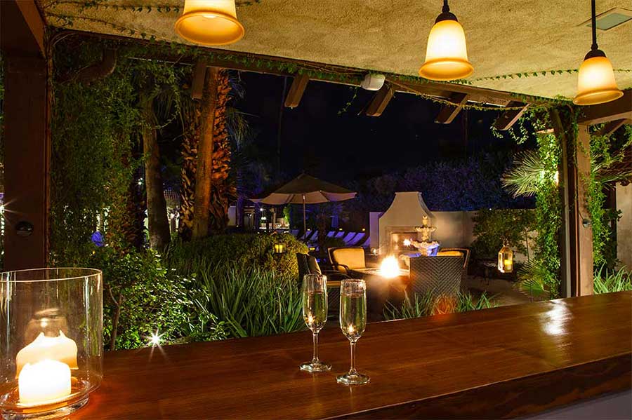 Two glasses of champagne at an outdoor bar at La Maison Hotel in Palm Springs, California
