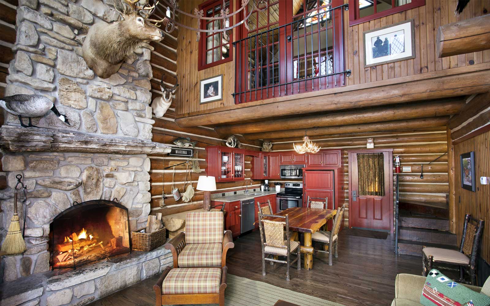 Fireplace and red kitchen of a log cabin at Big Cedar Lodge in Table Rock Lake, Missouri
