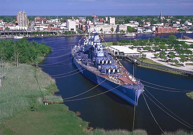 The battleship NORTH CAROLINA is moored downtown with many strong lines in Wilmington, North Carolina