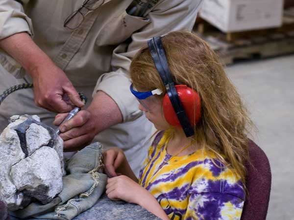 Cleaning dinosaur fossil found at Wyoming Dinosaur Center in Thermopolis