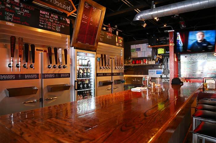 The bar, taps and chalkboard menu at Black Bridge Brewery in Kingman, AZ