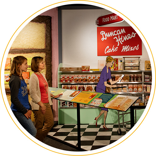 Visitors examining a food mart display at the Duncan Hines exhibit in the Kentucky Museum in Bowling Green, KY