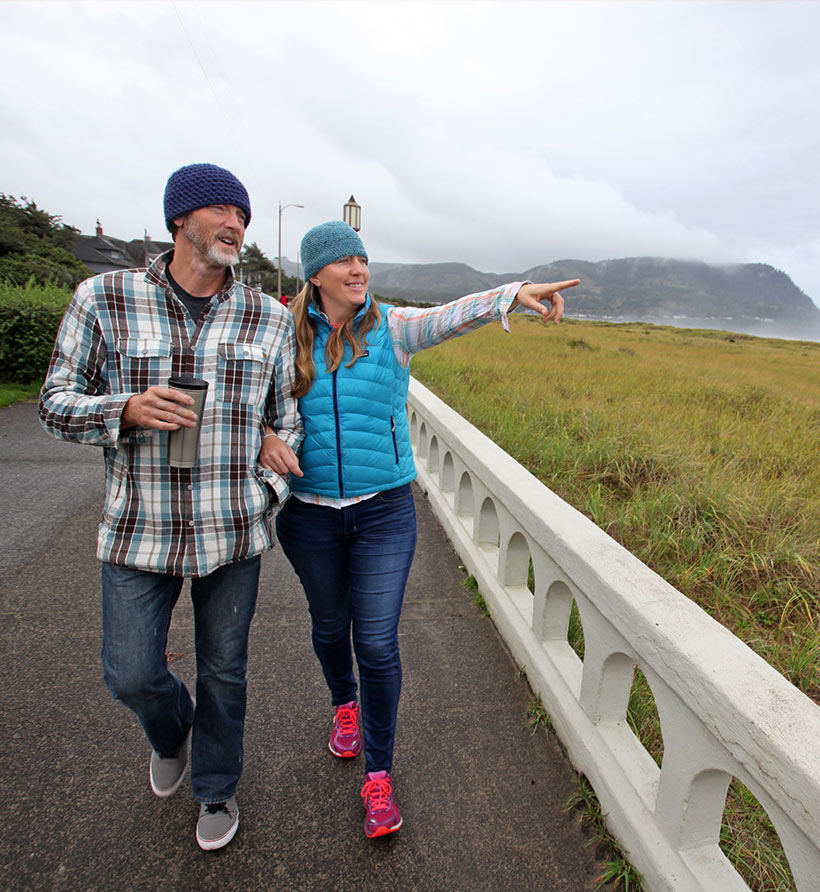 A couple walking near the coast in Seaside, Oregon