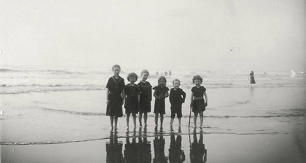 Historic picture of kids standing on the beach in Seaside, Oregon