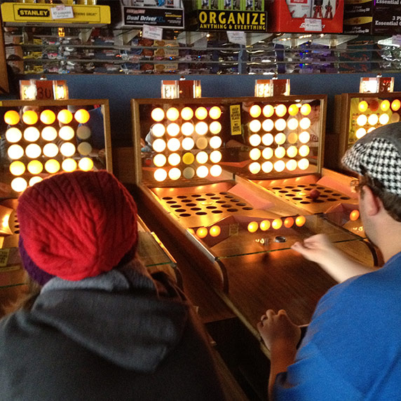 People playing game at Funland Arcade in Seaside, Oregon