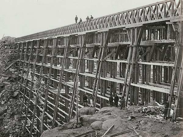 The original Dale Creek Crossing wooden bridge under construction above Dale Creek near Laramie, Wyoming