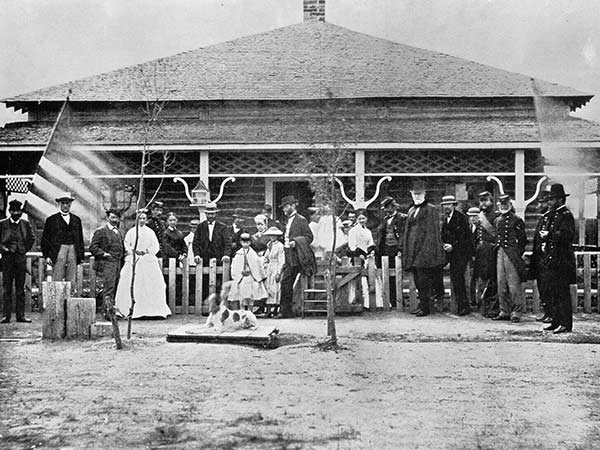People stand outside Keystone Hall circa 1868 in the historic Laramie, WY tent city