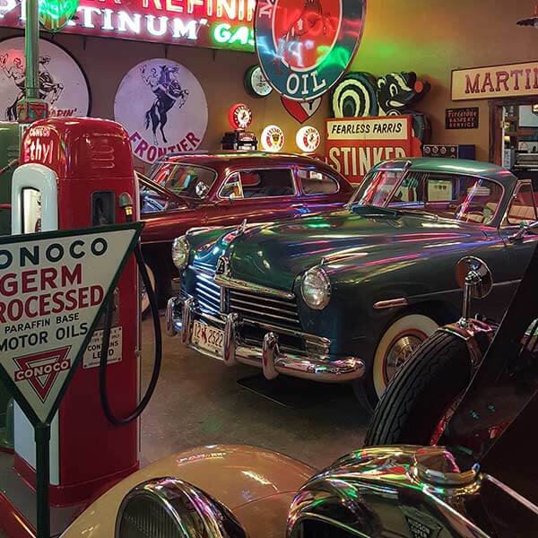 Classic cars and a gas pump at the Frontier Auto Museum in Gillette, WY