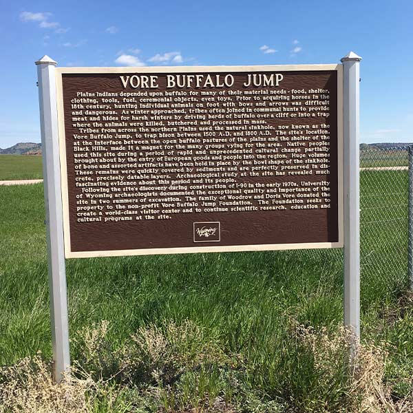 A brown sign for the Vore Buffalo Jump archeological site in Crook County, Wyoming