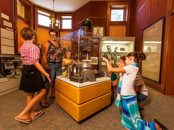 People observe an exhibit at the Rock Springs Historical Museum in Sweetwater County, WY