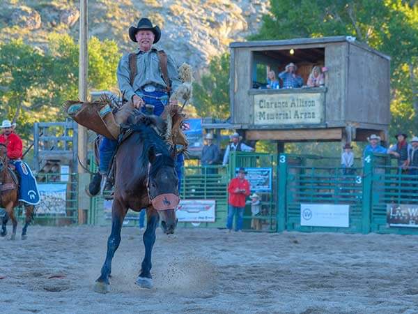 A man rides a horse in the Clarence Allison Memorial Arena at the Dubois Friday Night Rodeo in Wind River Valley, WY