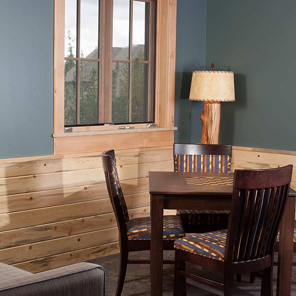 Furniture in the corner of a room that uses beetle kill wood as wainscot at the Yellowstone National Park Lodges in Wyoming