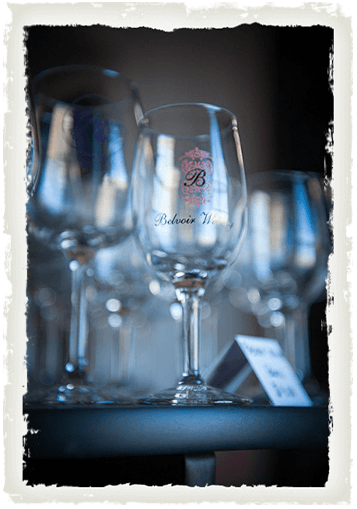 A wine glass engraved with the logo of Belvoir Winery in Liberty, MO