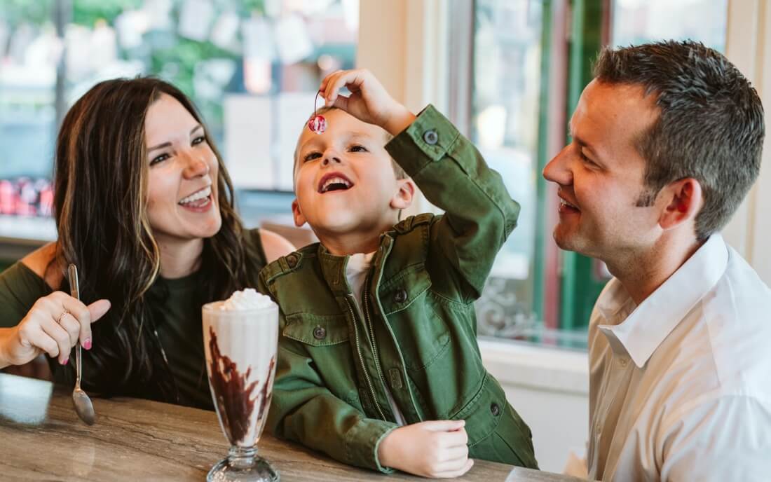 Parents and their son enjoy an ice cream sundae at Clinton’s Soda Fountain in Independence, MO