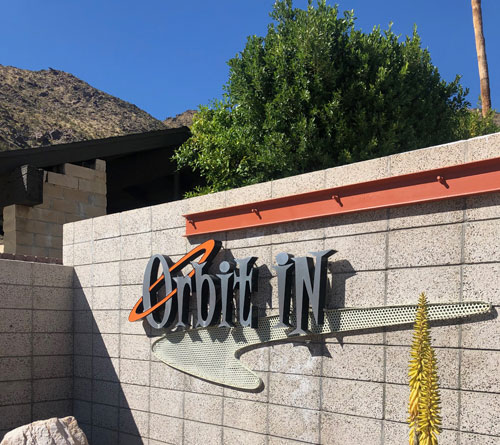 Orbit In hotel sign on a brick wall in Palm Springs, California