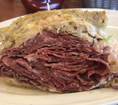 Large pastrami sandwich on a plate at Sherman’s Deli and Bakery in Palm Springs, California