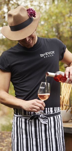  McEvoy Ranch employee pours a glass of dry rosé for a guest.