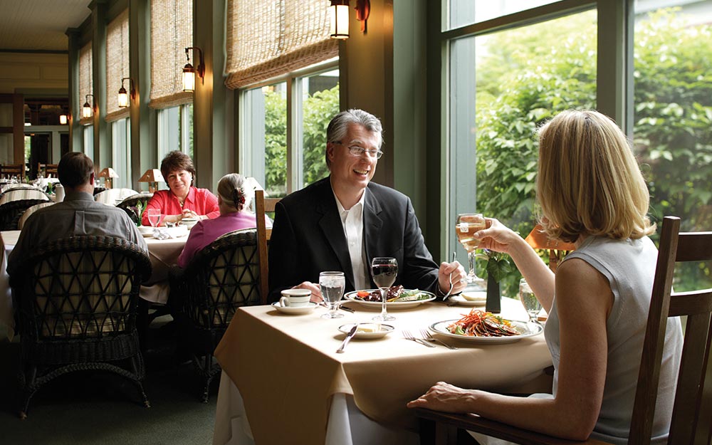 A couple enjoying drinks in the lounge at the Roycroft Inn in Buffalo, NY