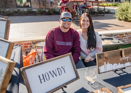 Two local artists sell signs that promote College Station at a craft fair in COllege Station, TX.