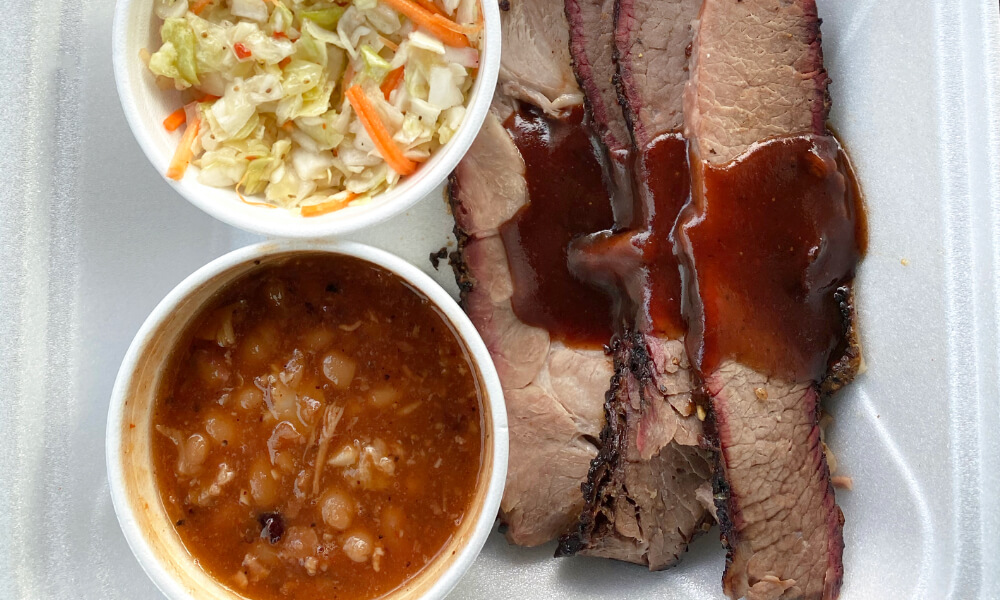 A plate filled with coleslaw, baked beans and BBQ in Sedalia, MO