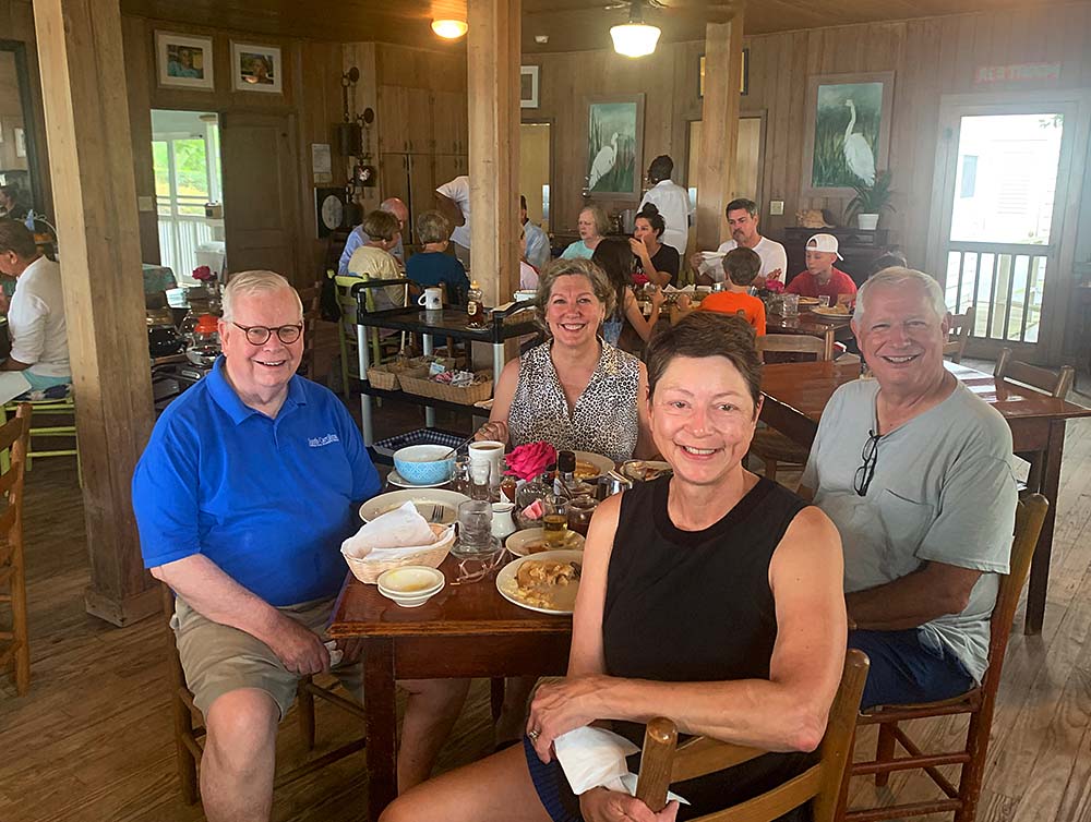 Two couples smile after eating breakfast at the Seas View Inn on Pawleys Island, South Carolina.