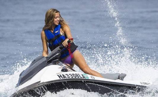 A woman drives a jetski on the lake in Bay Area Houston