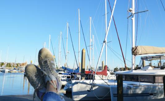 A man puts his feet up to rest while his boat is docked in Bay Area Houston