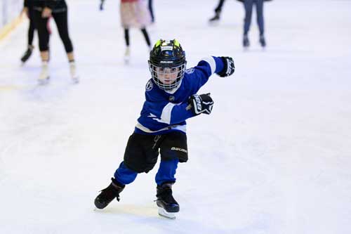 Child playing hockey indoors on Florida's Sport coast