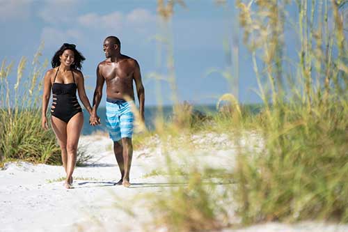 Couple walking on the beach on Florida's Sport coast