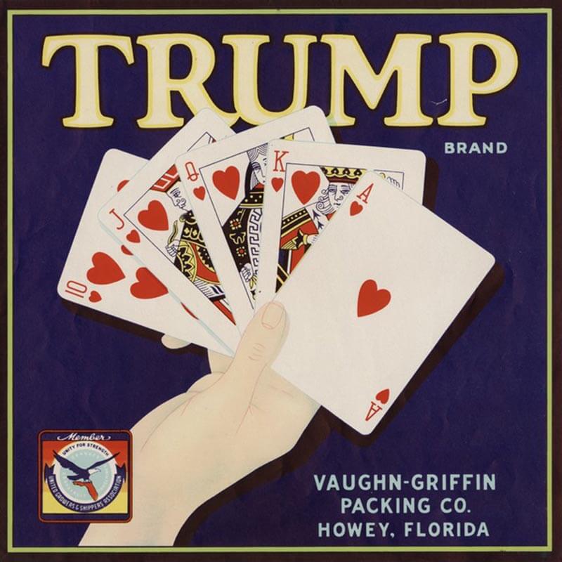 An illustration Trump brand citrus label is blue with white lettering. A hand holding cards shows a royal flush.