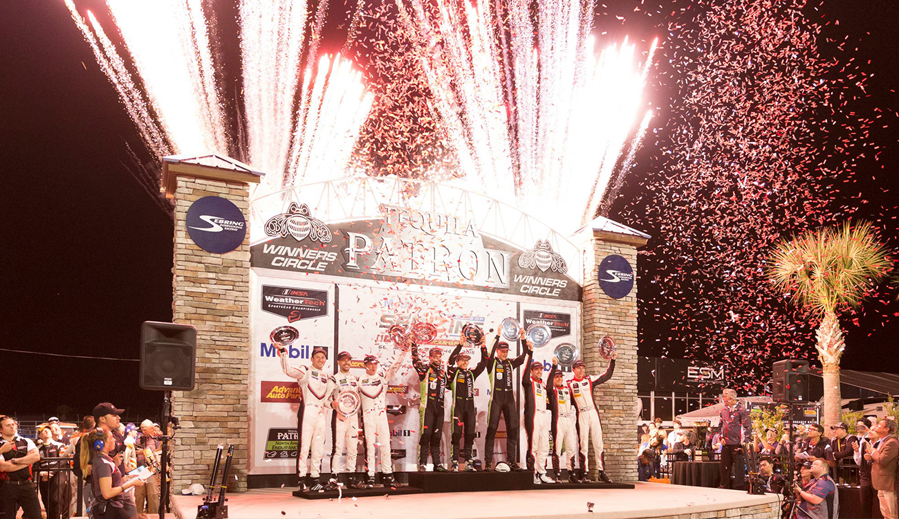 Fireworks sparkle behind three, 3-person crews on the winners stage at at the Sebring International Raceway in Sebring, Florida.