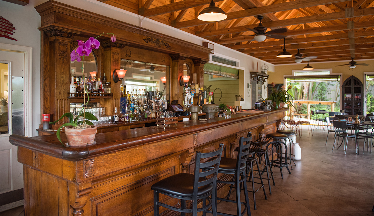 An antique style wooden bar is inside the main room of Faded Bistro & Beer Garden in Sebring, Florida.