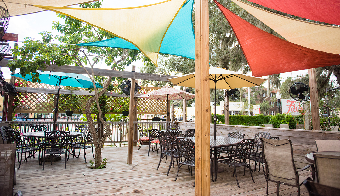 The front patio of Faded Bistro & Beer Garden is covered in colorful awning fabric in Sebring, Florida.