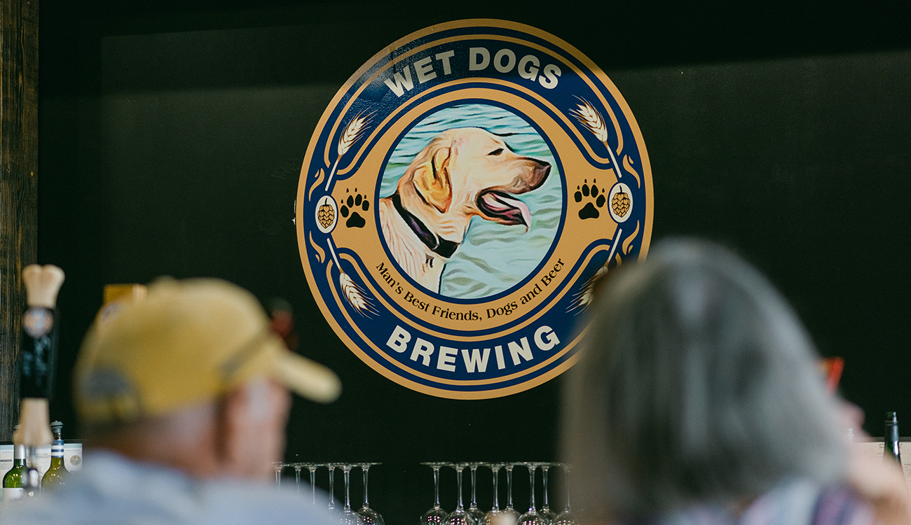 The large logo for Wet Dogs Brewing is painted on the black wall of the brewery in Lake Placid, Florida.