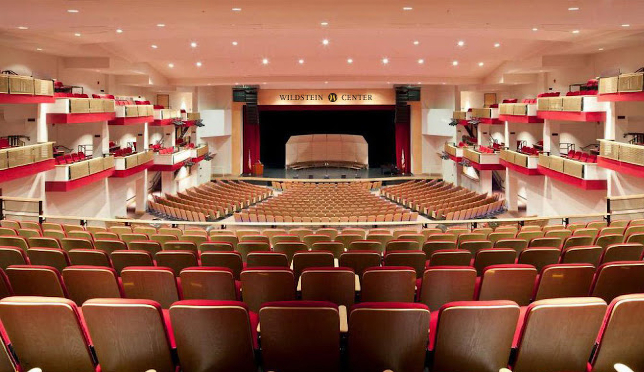 A large, emply auditorium with red chairs centers around a large stage at the Alan Jay Wildstein Performing Arts Center at South Florida State College in Avon Park, Florida.